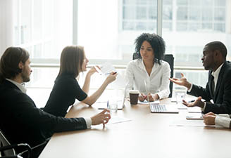 4 people talking in conference room